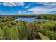 Scenic aerial view of a lake surrounded by lush green trees at 4424 Bonnie Loch Dr, Burlington, NC 27215