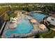 Aerial view of community amenities, including pools, a splash pad, and well-maintained landscaping at 4424 Bonnie Loch Dr, Burlington, NC 27215