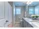 Bathroom with double sink vanity featuring granite countertops and soft grey cabinetry at 4424 Bonnie Loch Dr, Burlington, NC 27215