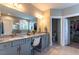 Bathroom featuring a double sink vanity with granite countertop, a walk-in shower and natural light at 4424 Bonnie Loch Dr, Burlington, NC 27215