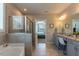 Bathroom boasting a tiled walk-in shower, soaking tub, and and sink vanity at 4424 Bonnie Loch Dr, Burlington, NC 27215