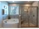 Bathroom featuring a walk-in shower, soaking tub and natural light from the window at 4424 Bonnie Loch Dr, Burlington, NC 27215