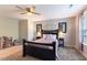 Bedroom featuring large bed with accent pillows, carpet flooring, and natural light from window at 4424 Bonnie Loch Dr, Burlington, NC 27215