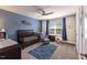Bedroom with a dark wood crib, rocking chair and blue accent wall at 4424 Bonnie Loch Dr, Burlington, NC 27215