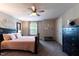 Bedroom featuring large bed with accent pillows, carpet flooring, and ceiling fan at 4424 Bonnie Loch Dr, Burlington, NC 27215