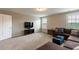 Bonus room featuring large sofa, ottoman, carpet flooring, and natural light from windows at 4424 Bonnie Loch Dr, Burlington, NC 27215