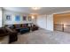 Bonus room featuring large sofa and ottoman with white trim and carpet flooring at 4424 Bonnie Loch Dr, Burlington, NC 27215