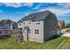 Rear exterior view of a two-story home with a well-maintained lawn and deck at 4424 Bonnie Loch Dr, Burlington, NC 27215
