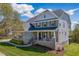 Charming home with covered porch and rocking chairs, brick and vinyl siding at 4424 Bonnie Loch Dr, Burlington, NC 27215