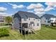 Rear exterior view of a two-story home with a well-maintained lawn and deck at 4424 Bonnie Loch Dr, Burlington, NC 27215
