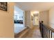 Hallway displaying stairway banister and an entry into the carpeted living area at 4424 Bonnie Loch Dr, Burlington, NC 27215