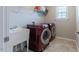 Laundry room featuring a utility sink and a red front loading washer and dryer at 4424 Bonnie Loch Dr, Burlington, NC 27215