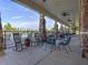 Outdoor patio features stone pillars, seating, and fans, providing a relaxing atmosphere by the pool at 4424 Bonnie Loch Dr, Burlington, NC 27215