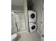 Bathroom featuring stacked washer and dryer, along with a stand-up shower with glass door at 48 Cullen Ct, Clayton, NC 27520