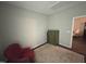 Cozy bedroom with neutral walls, a small dresser, and a red accent chair at 48 Cullen Ct, Clayton, NC 27520