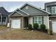 Charming home with stone accents, a garage, green shutters, and manicured bushes at 48 Cullen Ct, Clayton, NC 27520