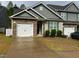 Charming townhome with stone accents, a two-car garage and inviting curb appeal at 48 Cullen Ct, Clayton, NC 27520