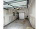 Unfinished garage featuring white cabinets, water heater, and a concrete floor at 48 Cullen Ct, Clayton, NC 27520