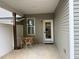 Covered patio area with an outdoor dining set and a white door at 48 Cullen Ct, Clayton, NC 27520
