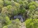 Aerial view of a home nestled among lush, mature trees providing a serene and private setting at 50 Beech Trl, Garner, NC 27529
