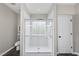 Bathroom featuring a glass-enclosed shower with a built-in bench and tile surround at 50 Beech Trl, Garner, NC 27529