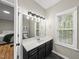 Bathroom with a vanity, large mirror, and natural light from the window at 50 Beech Trl, Garner, NC 27529