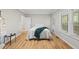 Bright bedroom featuring hardwood floors and a comfortable bed with natural light from the windows at 50 Beech Trl, Garner, NC 27529