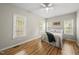 Comfortable bedroom featuring wood floors, natural light from the windows, and a ceiling fan at 50 Beech Trl, Garner, NC 27529