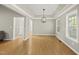 Bright dining room with hardwood floors, crown molding, and a modern chandelier at 50 Beech Trl, Garner, NC 27529