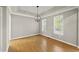 Bright dining room with hardwood floors, crown molding, and a modern chandelier at 50 Beech Trl, Garner, NC 27529