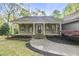 Charming home with a welcoming front porch, decorative columns, and a well-manicured lawn at 50 Beech Trl, Garner, NC 27529