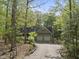 Two-car garage with an attached apartment above, nestled among mature trees at 50 Beech Trl, Garner, NC 27529