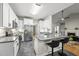 Spacious kitchen with white cabinets, stainless steel appliances, and breakfast bar area for casual dining at 50 Beech Trl, Garner, NC 27529