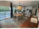 Bright dining area featuring hardwood floors, modern lighting and access to outdoor deck at 510 Braden Dr, Durham, NC 27713
