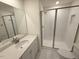 This is a full bathroom with a glass enclosed shower, toilet, and a single sink vanity at 512 Eastwood St, Durham, NC 27704