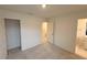 This is a bedroom with a carpeted floor, closet, and a bathroom with tile floor at 512 Eastwood St, Durham, NC 27704