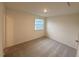 This is a bedroom with a carpeted floor and a window with blue house views at 512 Eastwood St, Durham, NC 27704