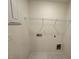 This is a laundry room with a wire rack, tile floor, and connections for a washer and dryer at 512 Eastwood St, Durham, NC 27704