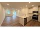 Open-concept living room with luxury vinyl flooring and abundant natural light at 512 Eastwood St, Durham, NC 27704