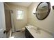 Well-lit bathroom featuring a shower-tub combo and vanity with ample counter space at 5200 Lorbacher Rd, Apex, NC 27539