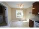 Sunlit kitchen nook featuring a window with backyard views and a ceiling fan at 5200 Lorbacher Rd, Apex, NC 27539