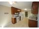 Traditional kitchen with wood cabinets, white appliances, and eat-in breakfast area at 5200 Lorbacher Rd, Apex, NC 27539