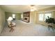 Large, bright living room with a fireplace, ample seating, and plenty of natural light at 5200 Lorbacher Rd, Apex, NC 27539