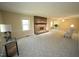 Bright and airy living room featuring neutral carpet, fireplace, and large windows at 5200 Lorbacher Rd, Apex, NC 27539