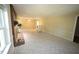 Spacious living room with a brick fireplace, ceiling fan, and large picture windows at 5200 Lorbacher Rd, Apex, NC 27539
