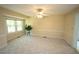 This inviting living space features carpet floors, a ceiling fan, and natural light from windows at 5200 Lorbacher Rd, Apex, NC 27539