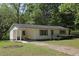 Charming single-story home with a covered porch and well-maintained front yard with gravel driveway at 5202 Lorbacher Rd, Apex, NC 27539