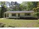 Single-story home featuring a charming covered entry and a well-manicured lawn with gravel driveway at 5202 Lorbacher Rd, Apex, NC 27539