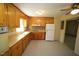 Traditional kitchen featuring wooden cabinets, laminate countertops, and modern appliances at 5202 Lorbacher Rd, Apex, NC 27539
