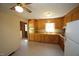 Functional kitchen with wood cabinetry, laminate countertops, and a window over the sink at 5202 Lorbacher Rd, Apex, NC 27539
